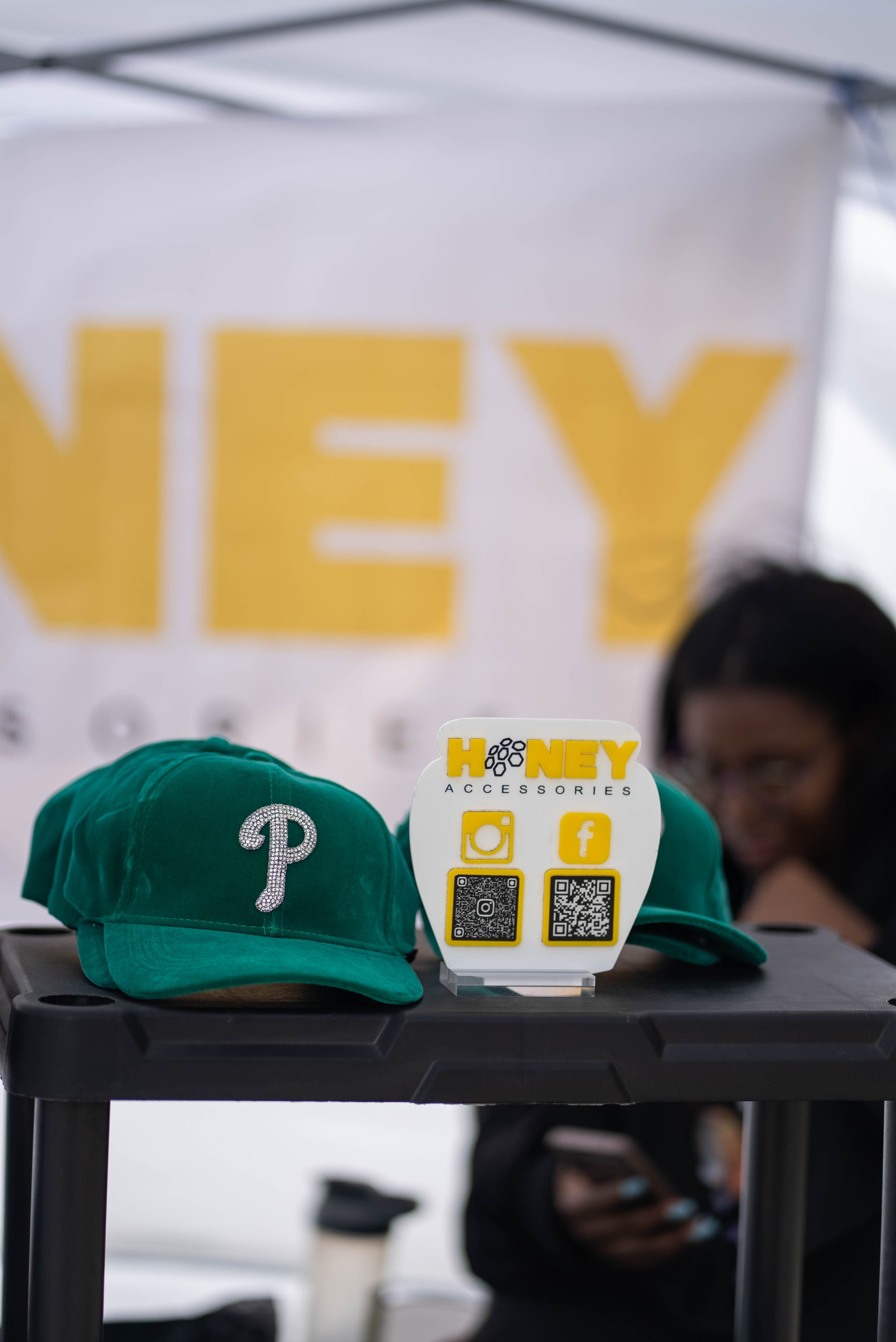Vendor table featuring hats and accessory display