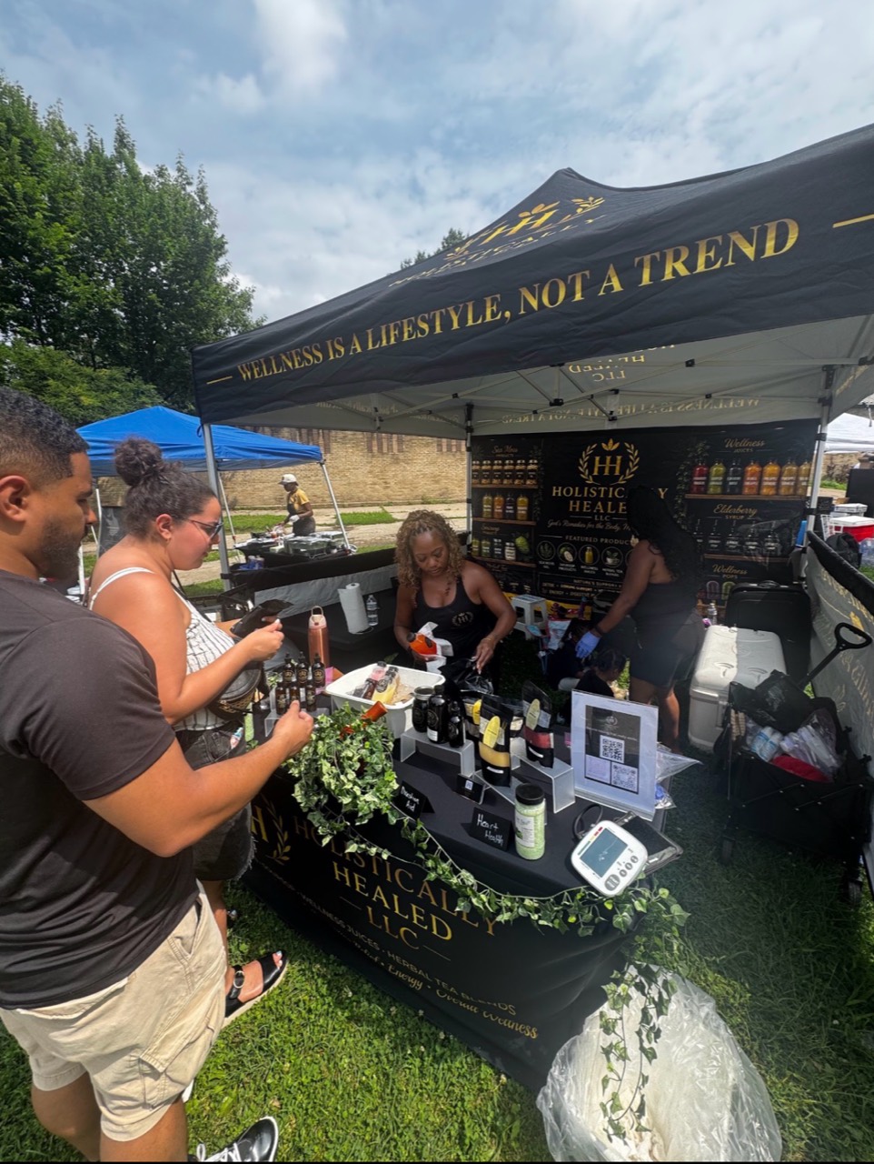 Visitors shopping at a wellness vendor booth at the African American Market